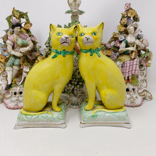 339 - A pair of pottery figures, of seated cats on cushions, 17.5 cm high, a late 19th century Meissen por... 