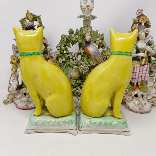 339 - A pair of pottery figures, of seated cats on cushions, 17.5 cm high, a late 19th century Meissen por... 