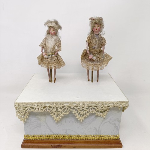 351 - A 19th century style music box, with two dancing figures, 17 cm wide