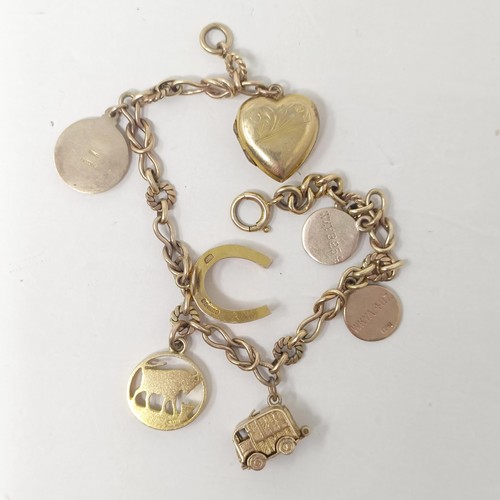 353 - A 9ct gold bracelet, with assorted charms, 20.6 g (all in)