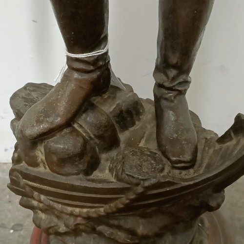 349 - A large French spelter figure, Le Secours, on a simulated marble base, 68 cm high