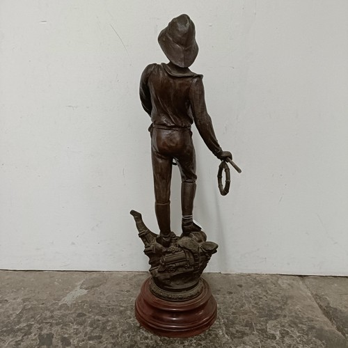 349 - A large French spelter figure, Le Secours, on a simulated marble base, 68 cm high