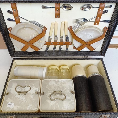 1005 - A picnic set, in a case with basket weave style decoration, little used, 50 cm wide