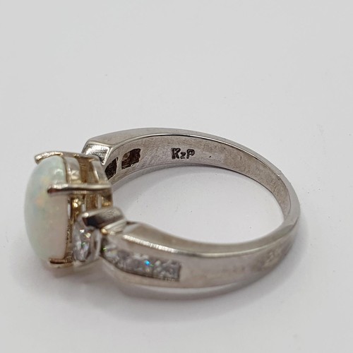 764 - An 18ct white gold, diamond and opal ring, ring size N