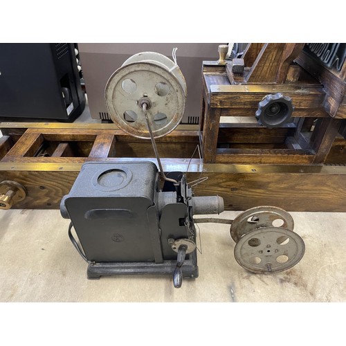 560 - An A Adams & Co Ltd bellows camera, on a brass and oak adjustable mount, assorted projectors and rel... 