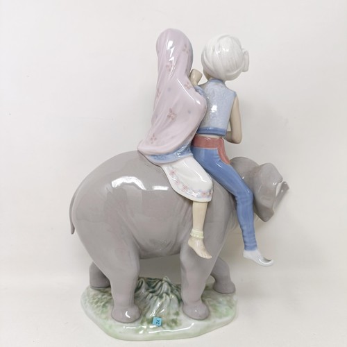 1556 - A Lladro group of two children riding an elephant, 24 cm high