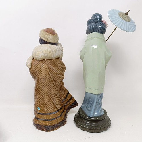 1557 - A Lladro figure of a boy carrying a lamb, 24 cm high, and a Lladro figure of a geisha holding a para... 