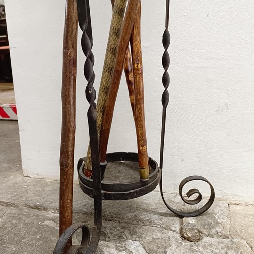 1604 - A snake skin walking stick, a carved horn walking stick, assorted other walking sticks and a stand