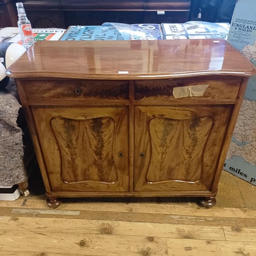 1625 - A mahogany cupboard, with a single drawer, above two cupboard doors, 45 cm wide, and a trolley (2)