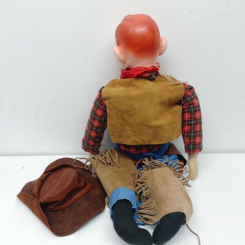 1546 - A Howdy Doody cowboy ventriloquist dummy, with a leather hat, waistcoat, chaps and holster, 63 cm hi... 