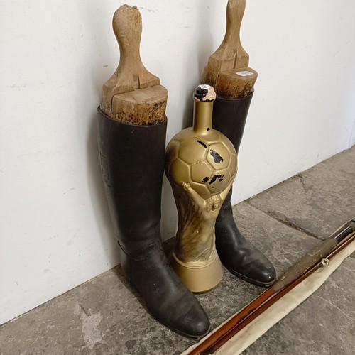 1458 - A pair of vintage riding boots and stretchers, a novelty World Cup bottle, and a fishing rod (4)