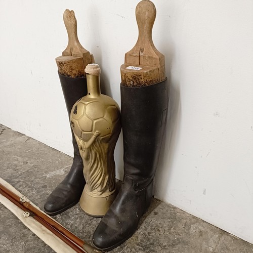 1458 - A pair of vintage riding boots and stretchers, a novelty World Cup bottle, and a fishing rod (4)