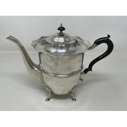 1076 - A George V silver teapot, with an ebonised handle, and a Continental sliver coloured metal salt, in ... 