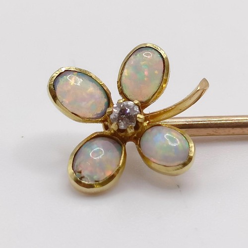 604 - An early 20th century yellow metal, diamond and opal stick pin, in the form of a flower  Provenance:... 