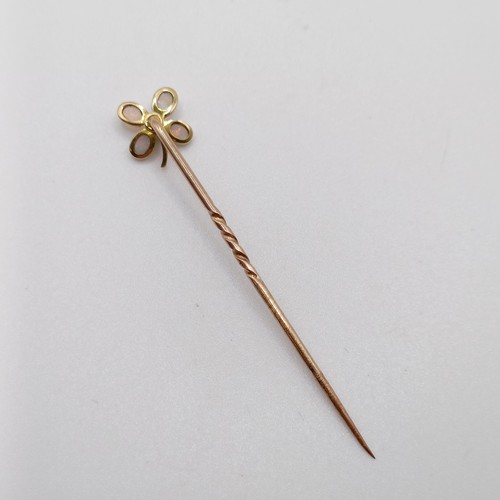 604 - An early 20th century yellow metal, diamond and opal stick pin, in the form of a flower  Provenance:... 