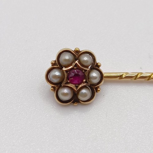 601 - A 19th century yellow metal, red stone and seed pearl stick pin  Provenance:  From a single owner co... 