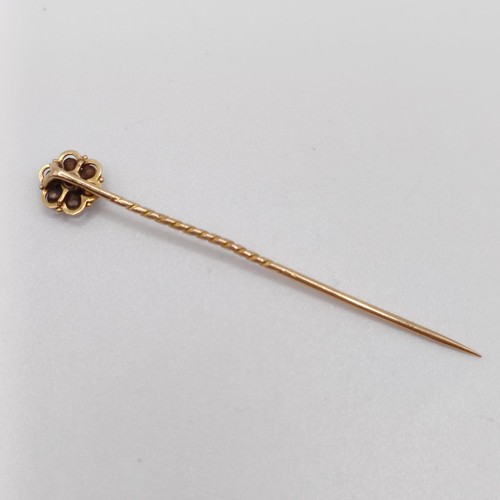 601 - A 19th century yellow metal, red stone and seed pearl stick pin  Provenance:  From a single owner co... 