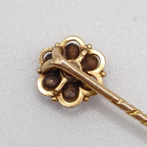 601 - A 19th century yellow metal, red stone and seed pearl stick pin  Provenance:  From a single owner co... 