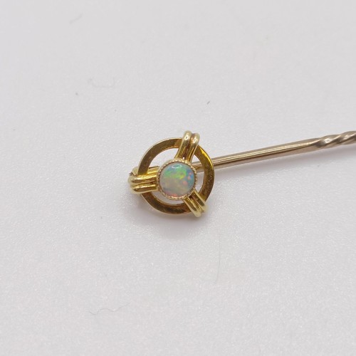 598 - A 20th century yellow coloured metal and opal stick pin  Provenance:  From a single owner collection... 