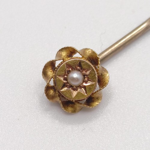 597 - A late 19th/early 20th century yellow coloured metal and seed pearl stick pin  Provenance:  From a s... 