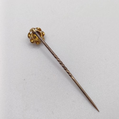 597 - A late 19th/early 20th century yellow coloured metal and seed pearl stick pin  Provenance:  From a s... 