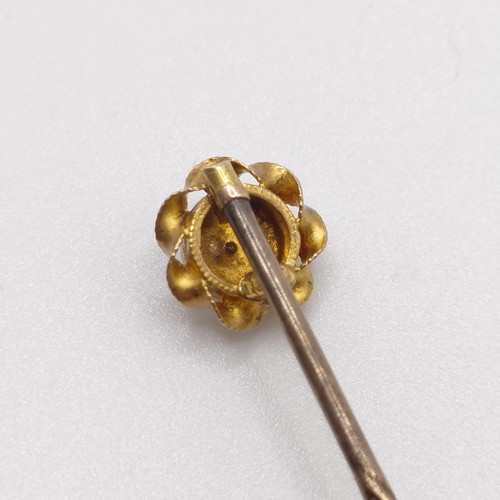 597 - A late 19th/early 20th century yellow coloured metal and seed pearl stick pin  Provenance:  From a s... 