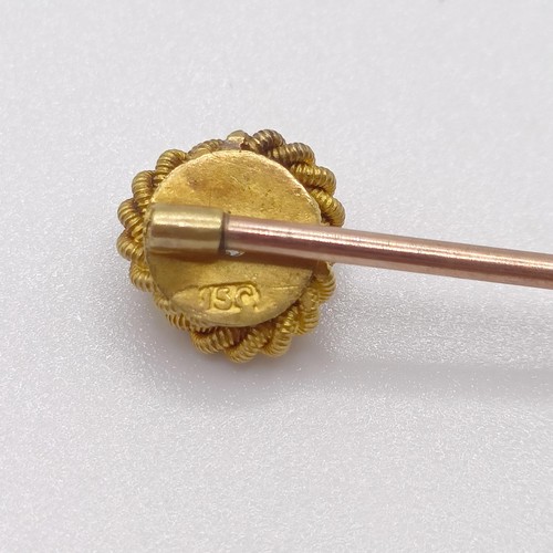 594 - A late 19th/early 20th century yellow coloured metal and diamond stick pin, in the form of a knot Pr... 