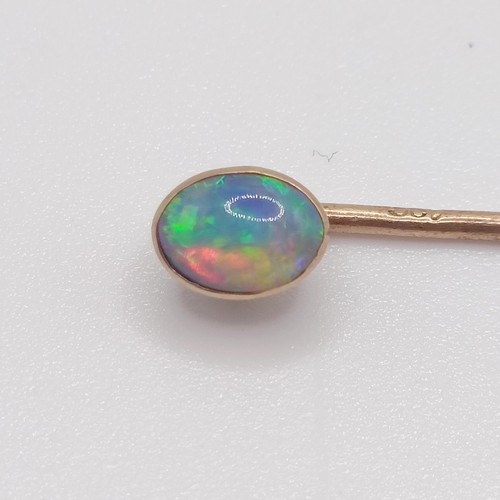 593 - A 20th century yellow coloured metal and opal stick pin  Provenance:  From a single owner collection... 