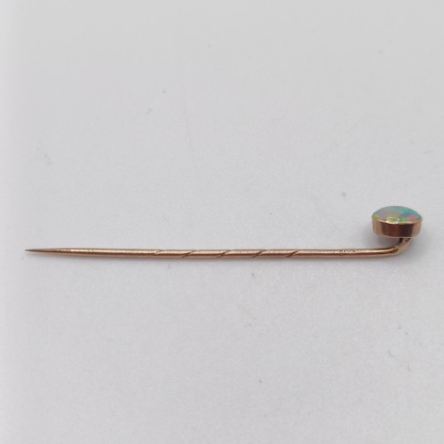 593 - A 20th century yellow coloured metal and opal stick pin  Provenance:  From a single owner collection... 