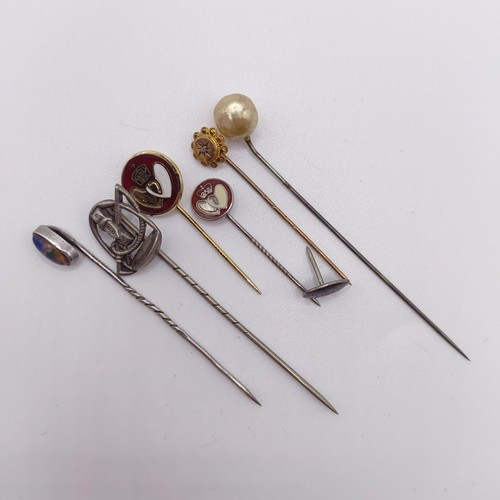 591 - A silver coloured metal stick pin, five other stick pins and a pin (7)  Provenance:  From a single o... 