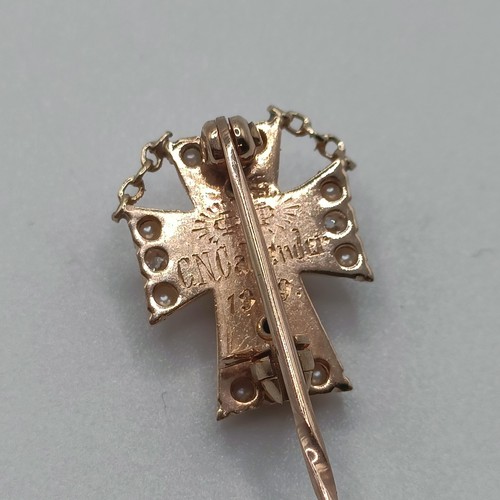 590 - An early 20th century white enamel, seed pearl and diamond stick pin, with the back engaved  Provena... 