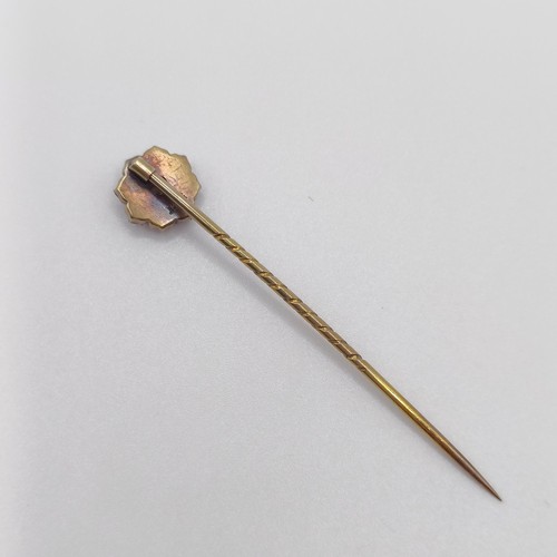 588 - A late 19th/early 20th century yellow metal and red stone stick pin  Provenance:  From a single owne... 