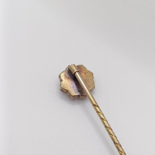 588 - A late 19th/early 20th century yellow metal and red stone stick pin  Provenance:  From a single owne... 