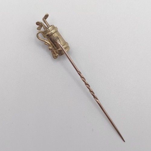 584 - A 20th century yellow metal stick pin, in the form of a set of golf clubs Provenance:  From a single... 