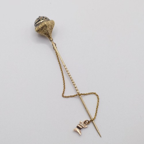 583 - A 19th century yellow metal and black enamel stick pin, in the form of a scepter   Provenance:  From... 