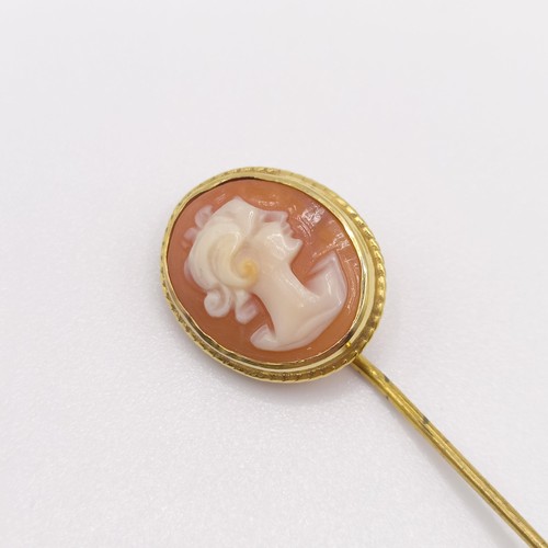 580 - A late 19th/early 20th century yellow metal stick pin, inset with a cameo, decorated lady  Provenanc... 