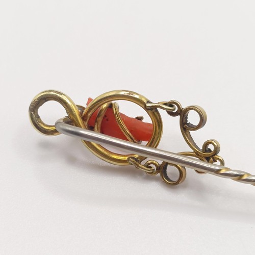 579 - A late 19th/early 20th century yellow metal and coral stick pin  Provenance:  From a single owner co... 