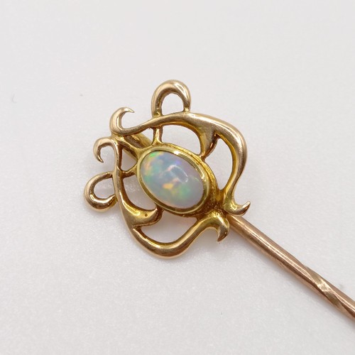 577 - An Art Nouveau style yellow metal and opal stick pin  Provenance:  From a single owner collection of... 