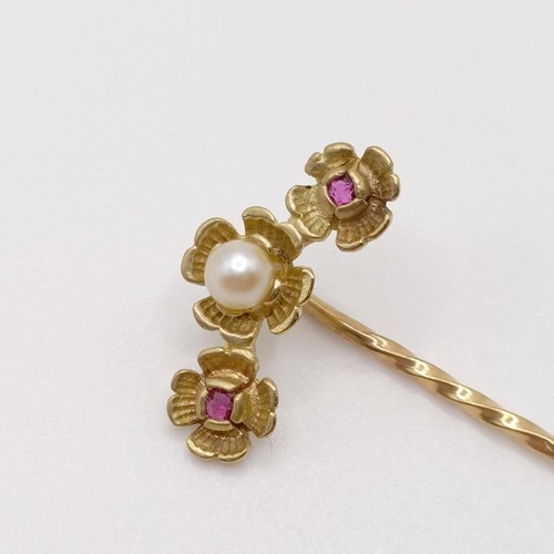 576 - A late 19th/early 20th century yellow metal, red stone and pearl stick pin  Provenance:  From a sing... 