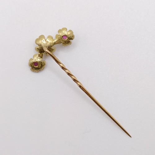 576 - A late 19th/early 20th century yellow metal, red stone and pearl stick pin  Provenance:  From a sing... 