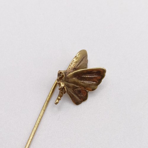 575 - An early 20th century yellow metal stick pin, in the form of a butterfly  Provenance:  From a single... 