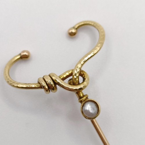 572 - A late 19th/early 20th century yellow metal and pearl stick pin, in the form of a noose  Provenance:... 