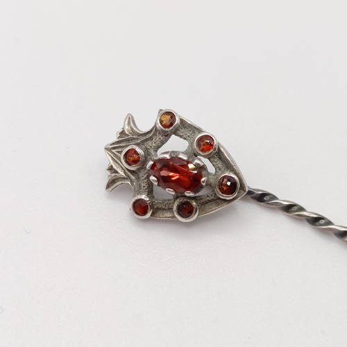 569 - A silver coloured metal stick pin, in the form of a dove, a silver coloured metal and orange stone s... 