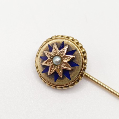 568 - A late 19th/early 20th century yellow metal, blue enamel and seed pearl stick pin  Provenance:  From... 