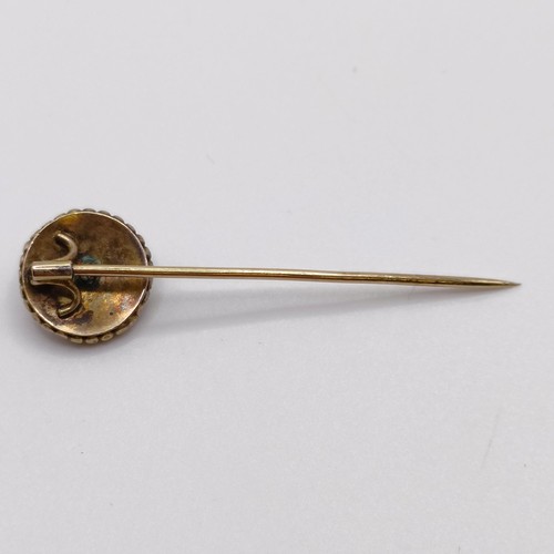 568 - A late 19th/early 20th century yellow metal, blue enamel and seed pearl stick pin  Provenance:  From... 