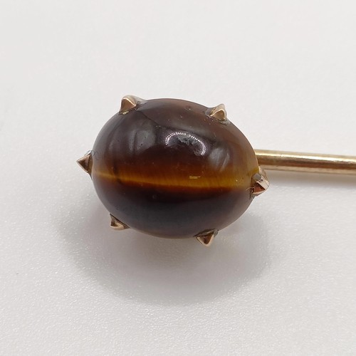 566 - A 20th century yellow metal and tiger's eye stick pin Provenance:  From a single owner collection of... 