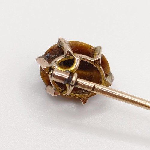 566 - A 20th century yellow metal and tiger's eye stick pin Provenance:  From a single owner collection of... 