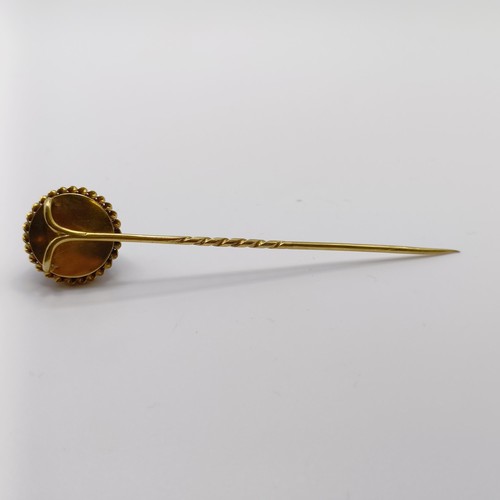 565 - A 19th century yellow metal, engraved cabochon cut purple stone and pearl stick pin  Provenance:  Fr... 