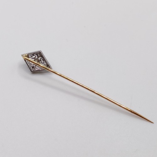 564 - An early 20th century silver coloured metal and yellow metal stick pin  Provenance:  From a single o... 