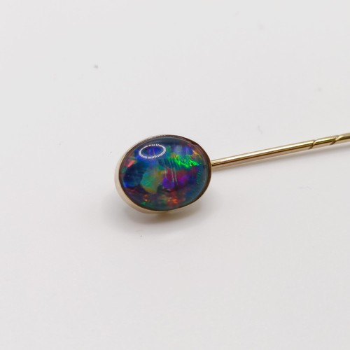 563 - A 20th century yellow metal and opal stick pin  Provenance:  From a single owner collection of Victo... 